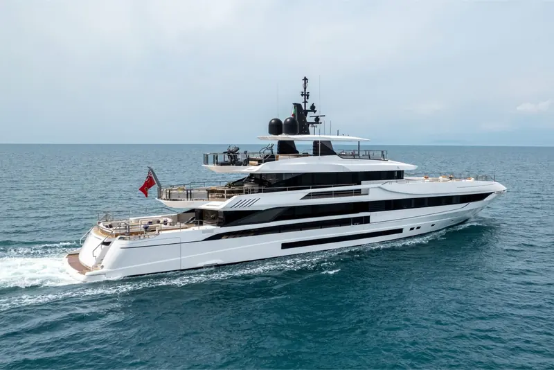 A sister hull flying the Red Ensign, showing the sun pad and gym equipment Mangusta fits as standard on the flybridge.