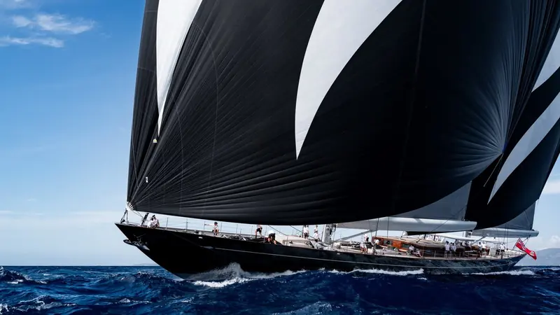 Black sails set wing-and-wing in a fresh breeze - Aquarius runs carbon rigging and a sail wardrobe built for genuine offshore passages, not just coastal cruising.