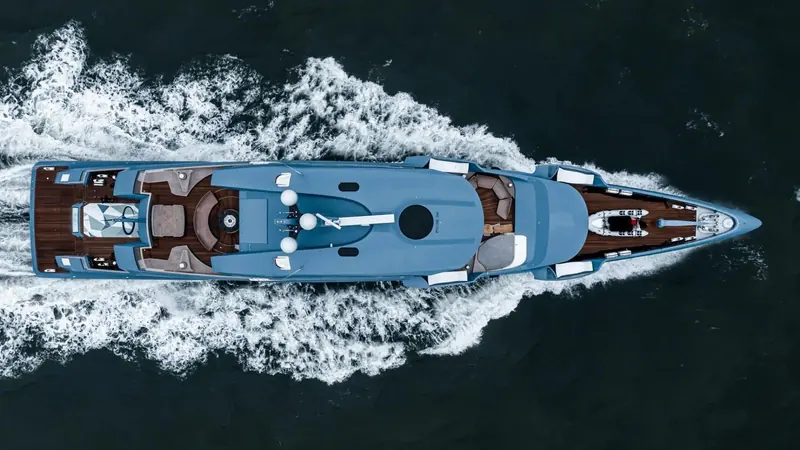 PHI under way from directly overhead, the pale ice-blue hull and twin tenders nested on the foredeck showing the yacht's severe, unornamented deck plan.