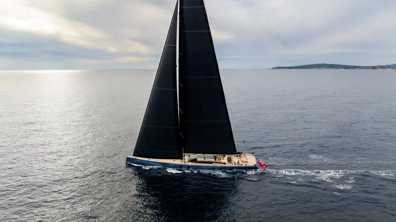 Underway with her red ensign flying, the low freeboard and long waterline that give Sarissa a race-boat turn of speed at nearly 60 metres.