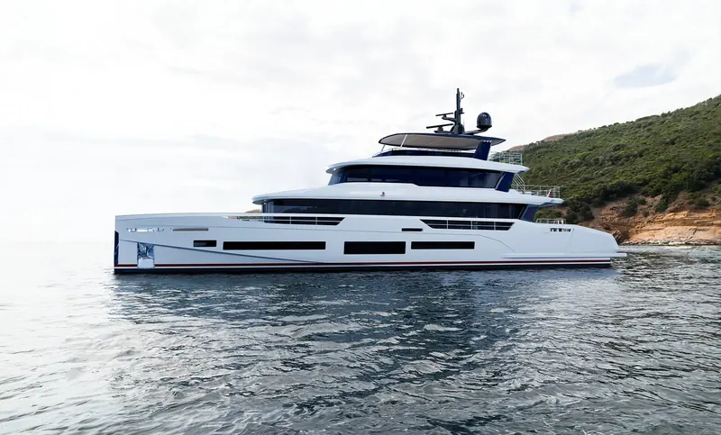 Broadside at anchor, showing the full three-deck profile and the low, wide window band that runs the length of the main deck.