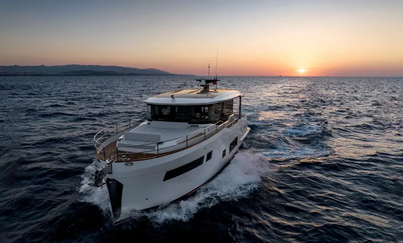 Stern quarter at sunset, the walkaround deck and low bulwarks that mark Sirena's coupe-style flybridge-free layout.