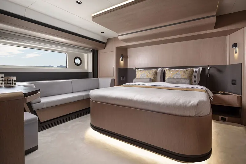 The owner's cabin, a centreline island bed with hull windows rather than portholes at head height.