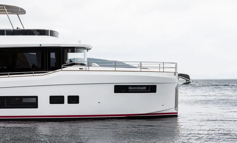 At anchor off a wooded Aegean headland, the low-slung profile that lets the Sirena 48 pass as a trawler rather than a flybridge cruiser.