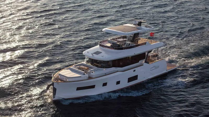 Under way in a light chop, the raised pilothouse and full-beam flybridge that define the Sirena line are visible in profile.