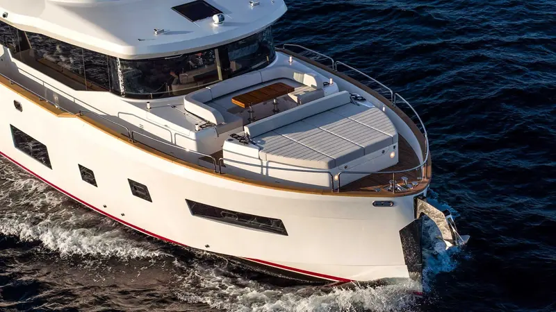 Looking straight down on the flybridge, the L-shaped seating and drop-down transom door reveal how much of the boat's living space sits above the main deck.