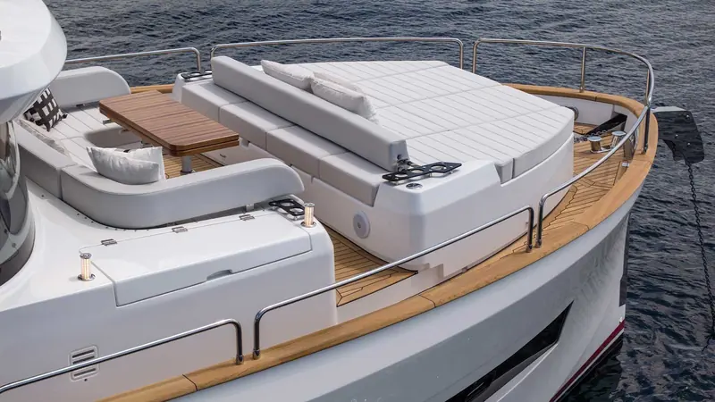 The foredeck sun pad folds down over the anchor locker, with a fold-out table for use at anchor rather than under way.