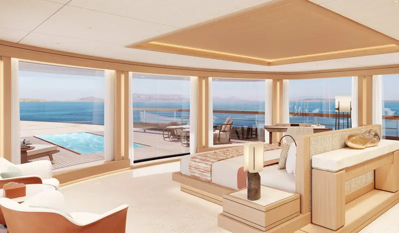 A window-side lounge pairs a built-in daybed with a full-height view of the anchorage, used as a quiet reading corner off the main salon.