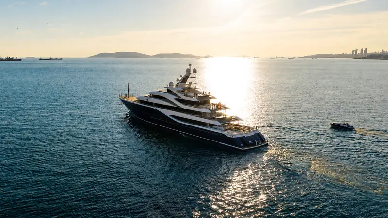 Angelique underway on the Sea of Marmara at sunset, with Istanbul's shipping lanes and skyline behind her.