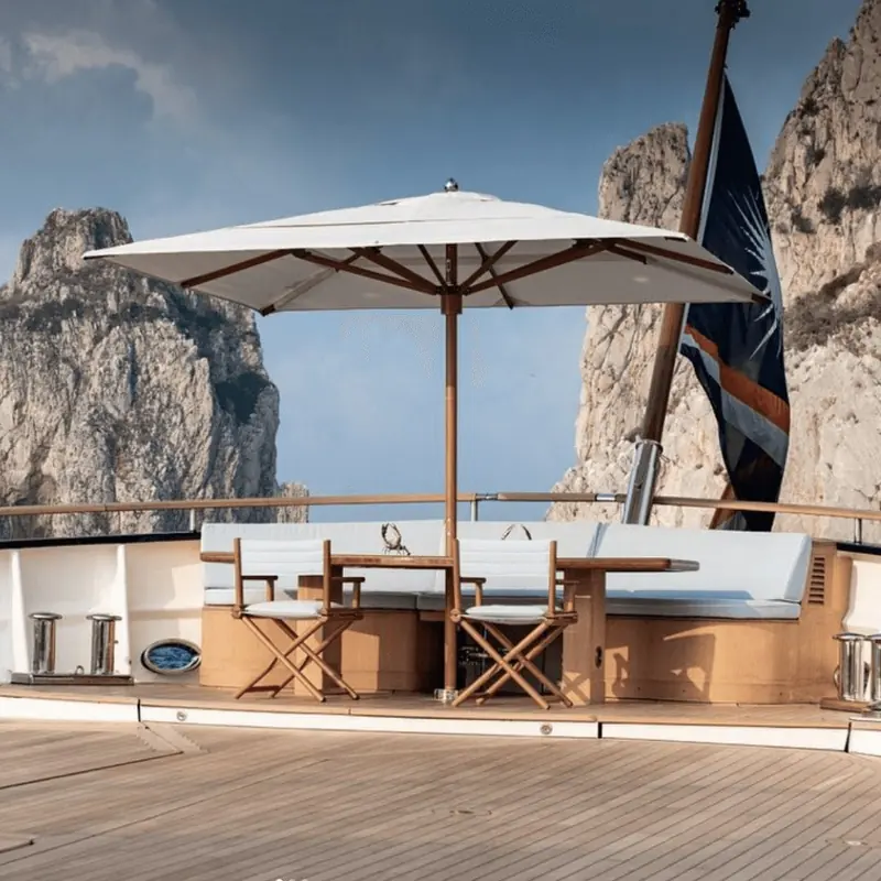 The aft deck aboard Angelique, laid for lunch under a teak-framed umbrella.