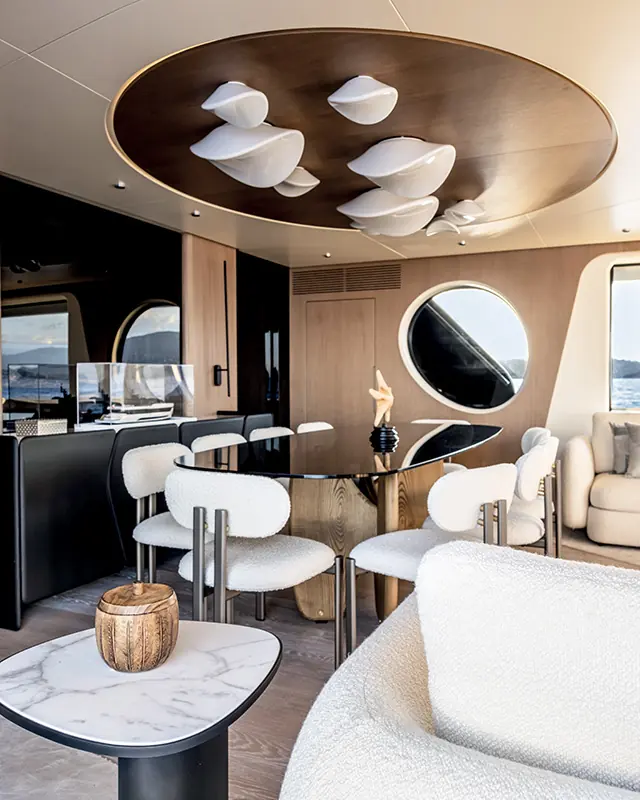 A dining nook and sculpted overhead light fitting inside an Arcadia A80.