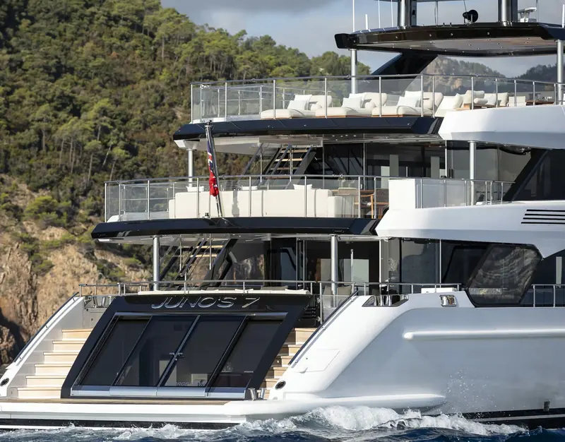 Junos 7's aft deck and swim platform against the Mediterranean coast, one of the Class 44M's four decks built around outdoor living.
