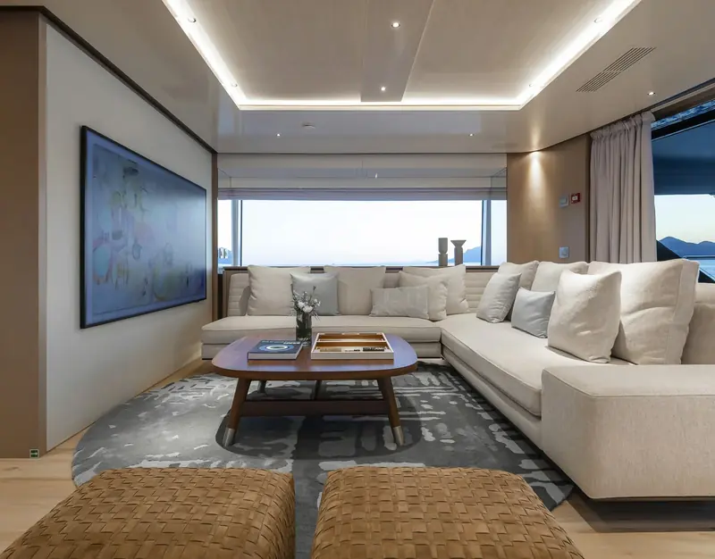A guest lounge with full-height glazing, part of a five-cabin, ten-guest layout on the 44-metre hull.