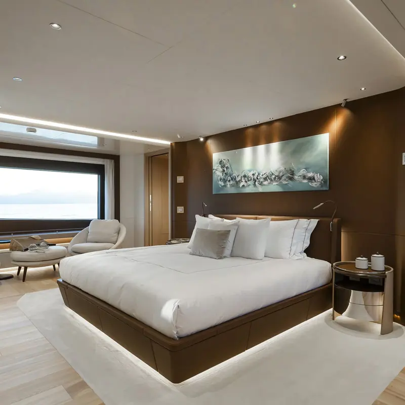 One of the Class 44M's five guest cabins, finished in a warm wood and brass palette.
