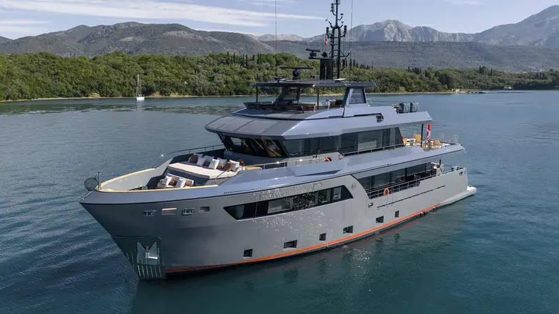 The broadside profile shows the class's forward-raked bow and low, layered superstructure, drawn to keep an 80-plus tonne explorer looking athletic at anchor.