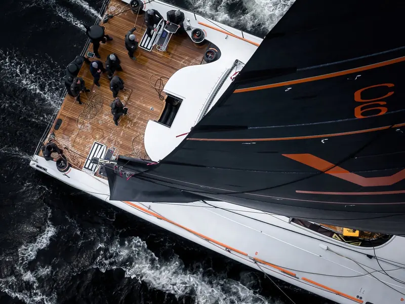 Looking aft along Raven's foredeck as the crew works the sails in a fresh breeze.