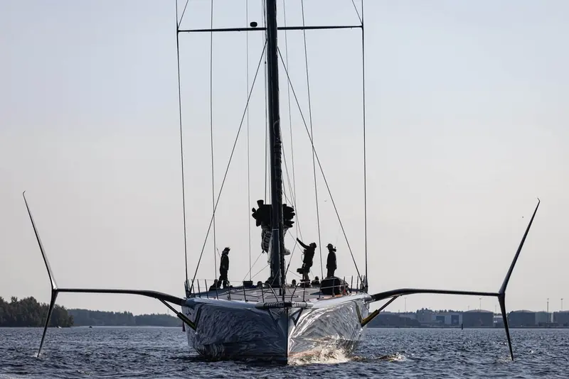 Raven seen from astern, her twin daggerboards and open transom visible above the wake.