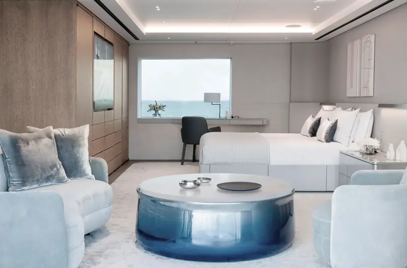 One of Entourage's guest staterooms, finished in bleached wood with a blue lacquered coffee table and dome-free ceiling.