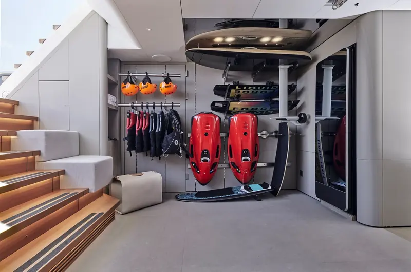 The water-toy garage below decks on Entourage, with wakeboards and personal watercraft racked beside the stairwell.