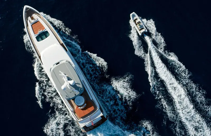 Solemates seen from above with her tender running alongside, showing the flared bow and unbroken foredeck of Claydon Reeves' exterior lines on the Mulder ThirtySix hull.