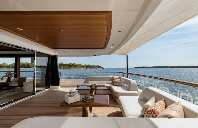 A covered corner of Solemates' aft deck, her name visible reflected in the railing glass.