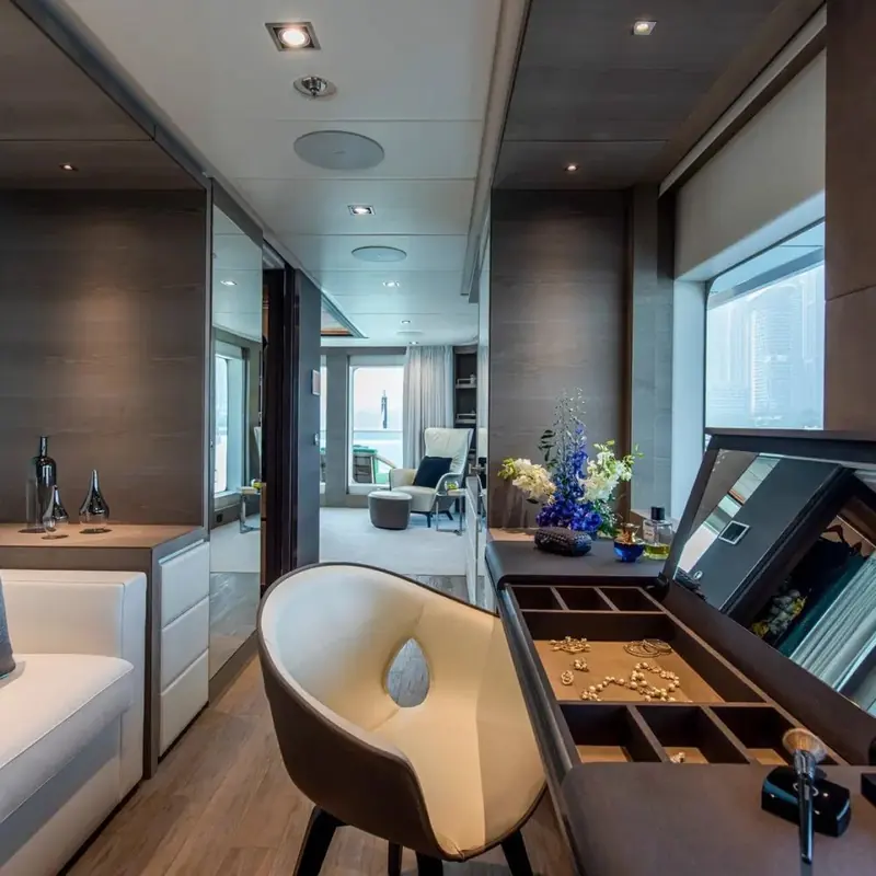 A dressing room off the owner's suite, fitted with a jewellery console and a mirrored wall that borrows light from the stateroom beyond it.