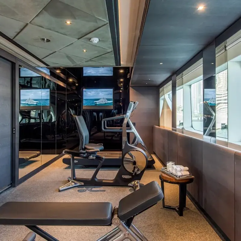 An onboard gym mirrored floor to ceiling, one of the amenity spaces Gatto's studio has made a signature of the yard's largest models.