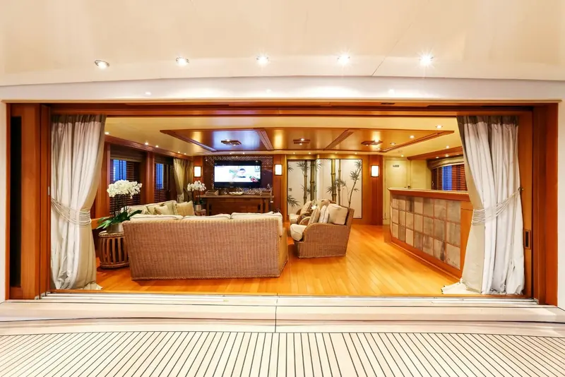 Esmeralda's main salon, wood panelling and a curved banquette built around a low table.