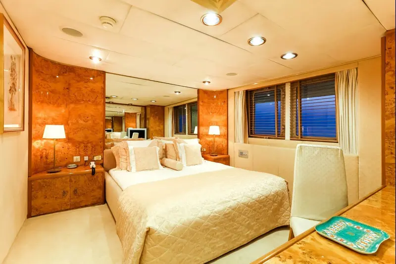 A guest cabin aboard Esmeralda, dressed in warm wood tones typical of her 1980s interior.