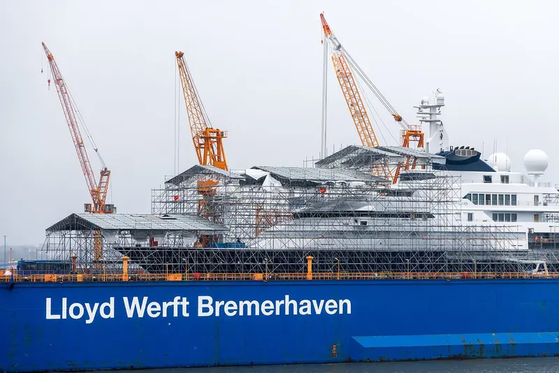 Under scaffolding at Lloyd Werft in Bremerhaven, Octopus takes shape on the slipway during her build.