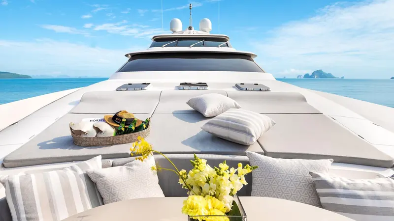 The foredeck lounge, styled for a charter guest, one of the outdoor living spaces Espinosa's raised-pilothouse layout frees up by moving the helm up a deck.