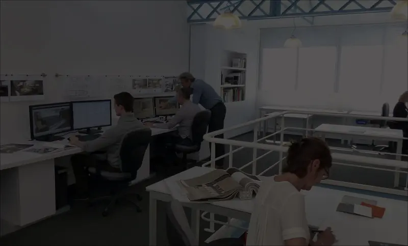 Designers at work at the Franck Darnet studio, sketches and material boards on the desks around them.