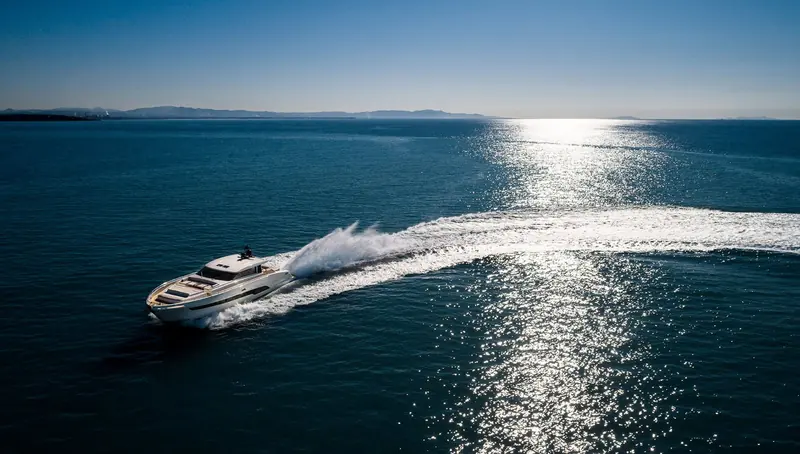 A De Simoni-designed motor yacht running at speed, the low, open sheer line that has marked his work since the first open-yacht Pershings of the 1980s.