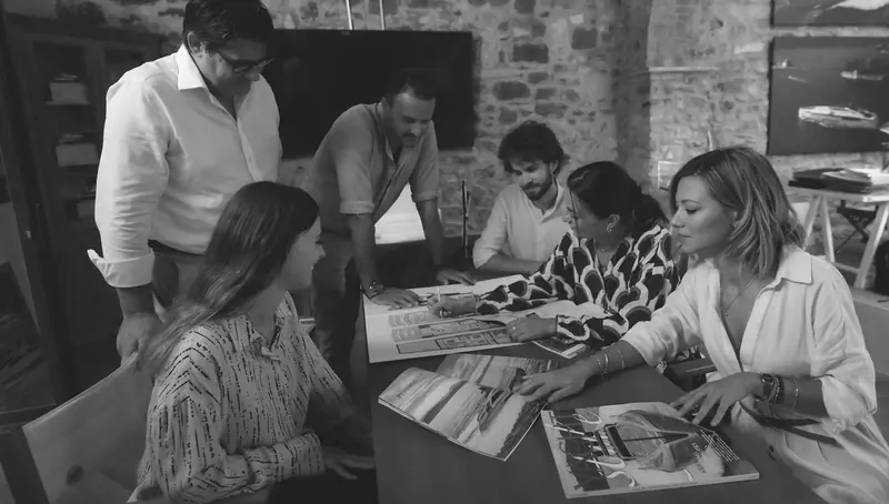 The studio at work on a new project, general arrangement drawings spread across the table - De Simoni still reviews every layout personally.