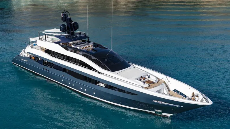 Irisha from above, dark curved glass wrapping the wheelhouse and a sun pad set into the foredeck.