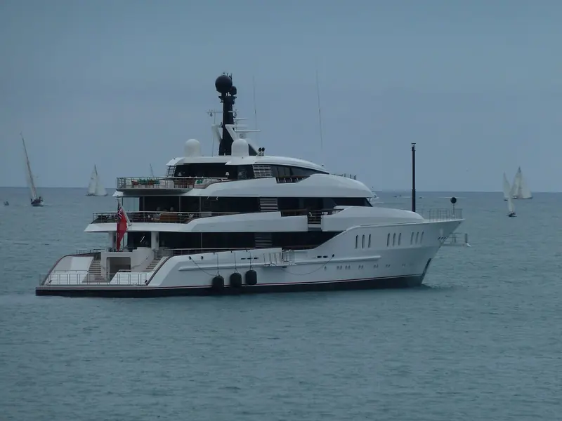 Vanish lies at anchor off Antibes with classic sailing yachts working in the background.