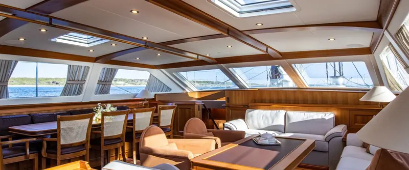The deckhouse saloon aboard Path, glazed on three sides to keep the owner's family connected to the deck and the water in any weather.