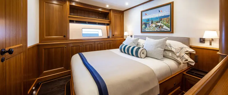 One of Path's guest cabins, finished in the same warm joinery as the saloon and study one deck below.