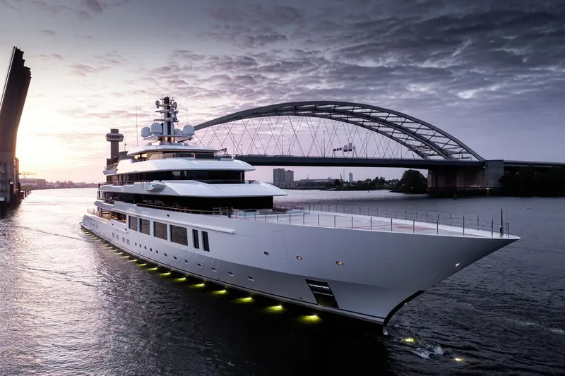Leviathan alongside at dusk during fit-out, her sun deck still wrapped for protection ahead of delivery.