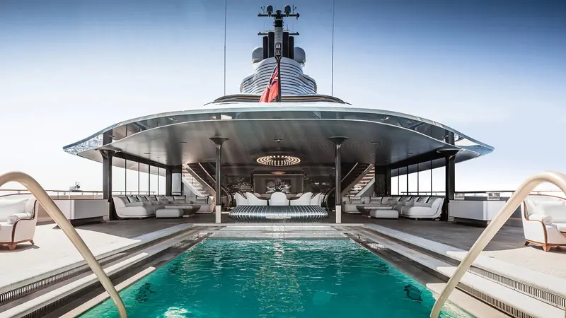 The pool deck under Jubilee's canopy, built around compound curves that gave Oceanco's paint shop real trouble.