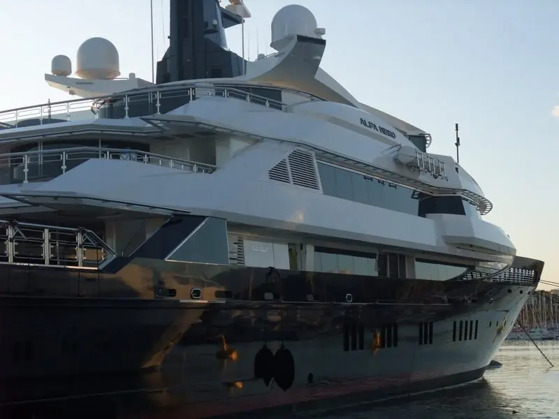 Warm dusk catches the bow and forward decks of Alfa Nero at Antibes.