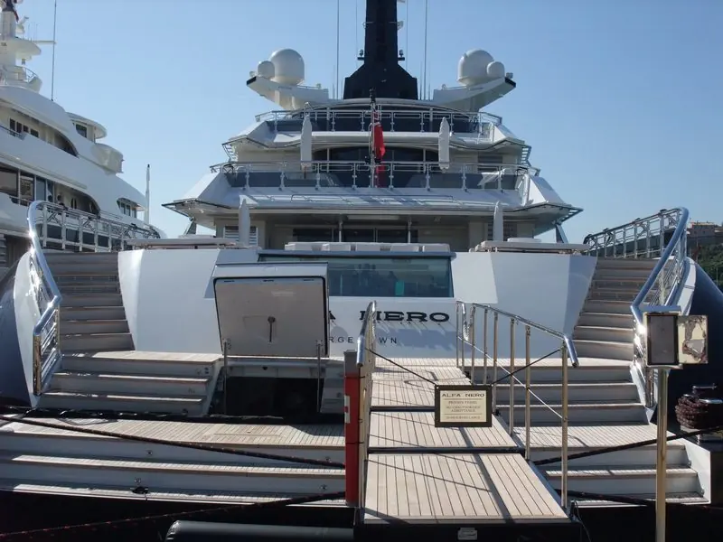 Twin stairways drop to the boarding passerelle at the stern of Alfa Nero in Antibes.