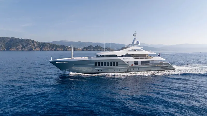 Reliance, the 55 metre steel Heesen delivered in 2023, underway off the Mediterranean coast in the shark-grey hull colour Omega Architects gave her.
