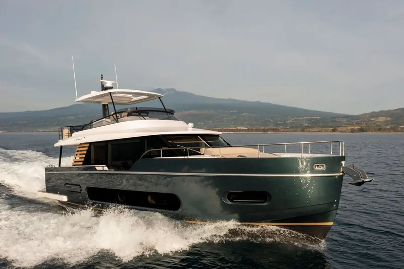 The Magellano 60 running off the Sicilian coast, her semi-planing Dual Mode hull switching between an efficient displacement mode and this faster setting on the same underwater lines.