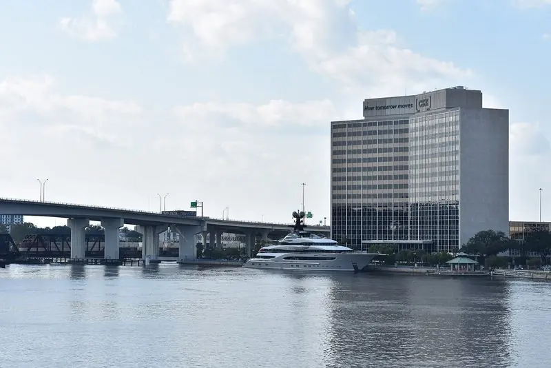 Downtown Jacksonville rises behind Kismet as she sits against the riverfront.
