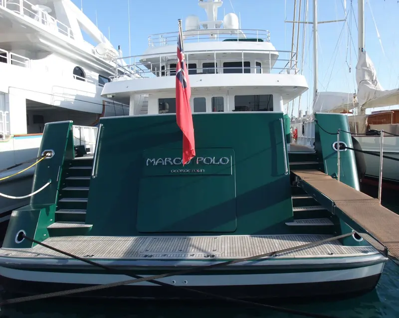Marco Polo, the 44.8m Cheoy Lee motor yacht delivered in 2007 to a Ron Holland Design exterior, moored stern-to with her name and George Town, Cayman Islands hailing port on the transom.