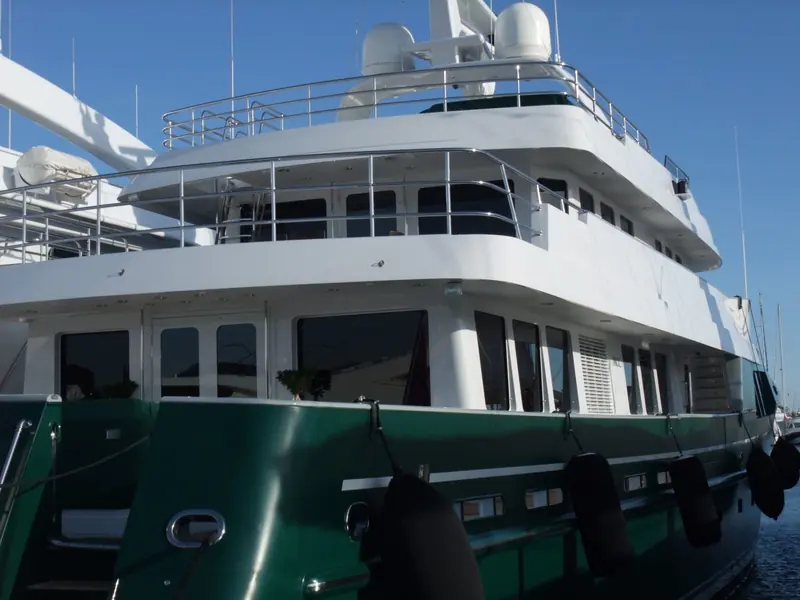 Marco Polo's port bow and superstructure, showing the raked pilothouse glazing and green hull that mark the Marco Polo series Doyle worked on as head designer at the Kinsale office.