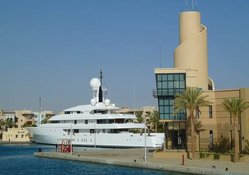 Ilona lies alongside at Port Ghalib with palms and marina buildings crowding the quay.