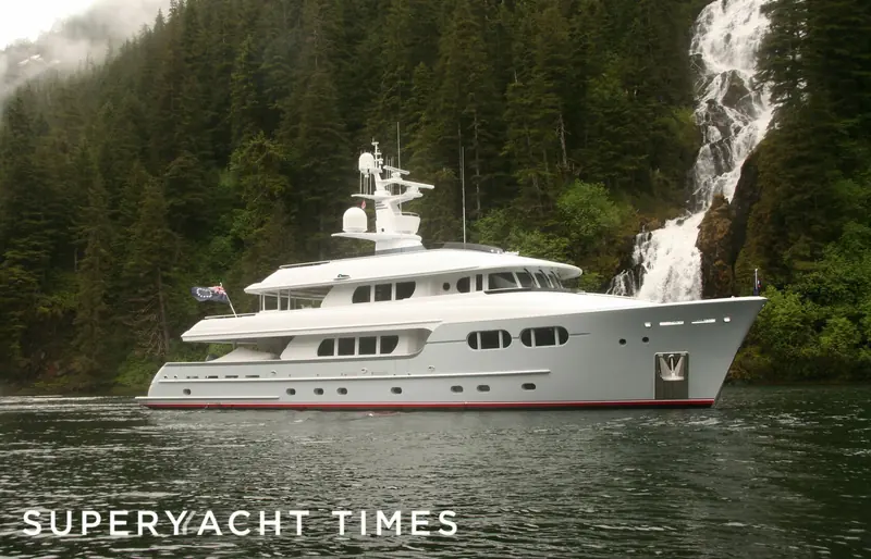 Marama runs past a waterfall on a forested shoreline, one of the expedition cruising grounds she was built for.
