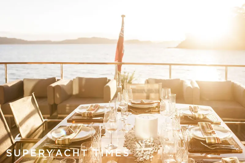 A table laid for sunset drinks on Marama's aft deck, glasses catching the low light.